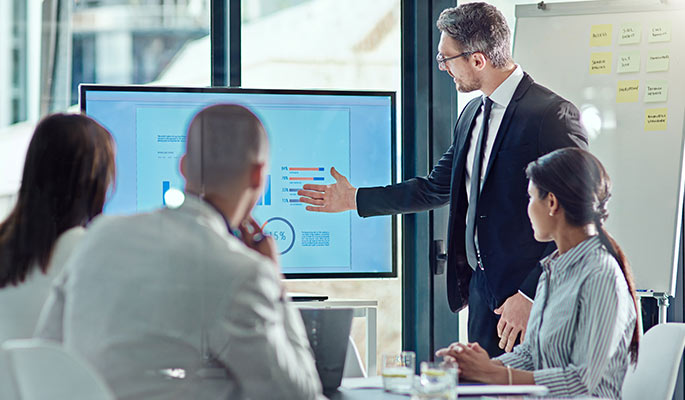 Diverse team reviewing charts in a meeting