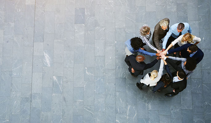 Overhead view of a group of people standing in a spiral