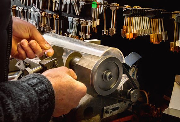 close-up of a man cutting keys in a hardware store