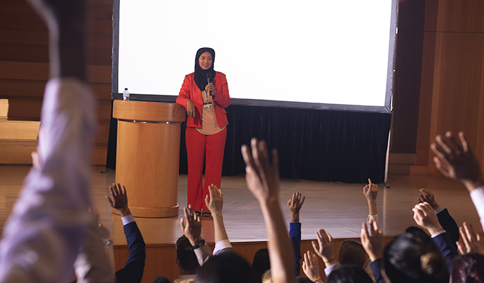 A speaker addresses conference attendees on diversity and inclusion topics