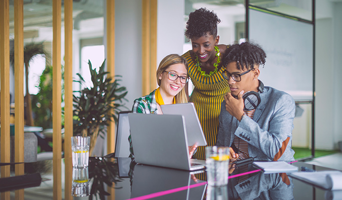 A group of employees engage with a blended digital learning package