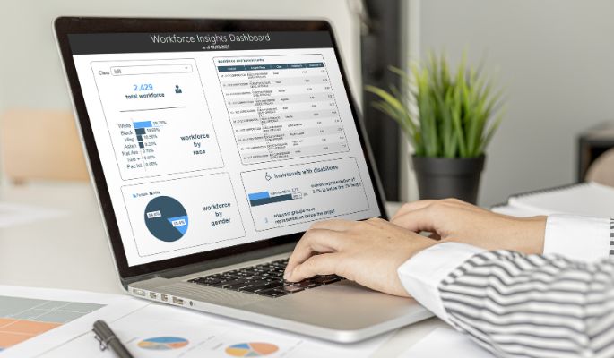 "A user interacts with the new Affirmity Workforce Insights dashboard design on a laptop computer"