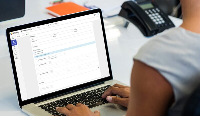 Photograph showing over the shoulder view of an employee using the talent decisions software module interface