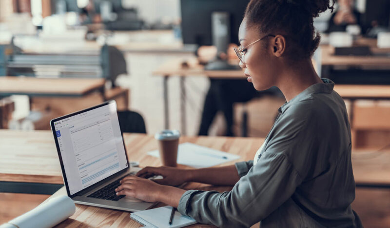 Photograph showing an employee using the talent decisions software module while seated at their laptop